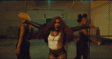 a woman in a white tank top and shorts is dancing