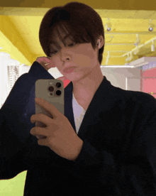 a young man is taking a selfie with his iphone