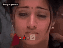 a close up of a woman 's face with the letter s visible