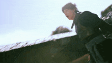 a blurry picture of a man standing in front of a fence