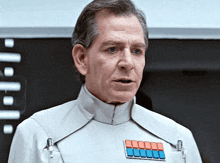 a man in a white uniform has a badge on his chest