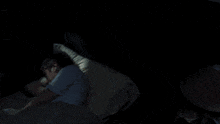 a person laying in bed with a light coming out of it