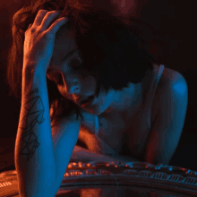 a woman with a tattoo on her arm that says ' i 'm sorry '