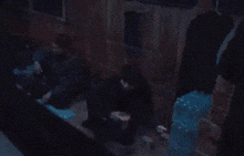 a blurry picture of a person standing in front of a window with a fireball coming out of it .