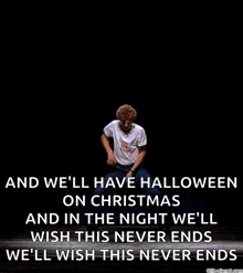 a man is dancing on a stage in the dark with a quote that says `` and we 'll have halloween on christmas '' .