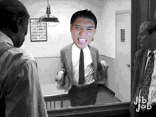 a man in a suit and tie looks at himself in a mirror with jib jab written on the bottom