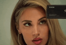 a close up of a woman 's face with a camera that says yiko2 on it