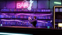a man is standing at a bar with a neon sign that says bar