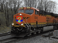 a bnsf train with a dragon on the front of it