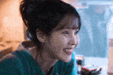 a close up of a woman 's face with a smile