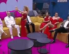 a group of people are sitting on a couch in a living room .