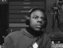 a black and white photo of a man wearing headphones and smiling
