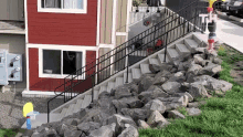 stairs leading up to a red house with a basketball hoop in front of it