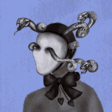 a person wearing a mask with snakes on it