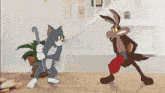 a cartoon of tom and coyote fighting each other