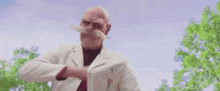 a man wearing a helmet , goggles and a mustache is eating a piece of meat .