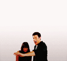 a man and woman playing with a red ball on a white background