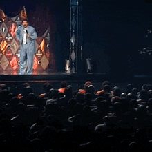 a man stands on a stage with the words muthafucka for what