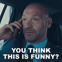 a man talking on a cell phone with the words you think this is funny