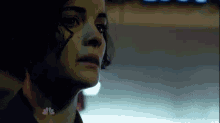 a close up of a woman 's face in a dark room