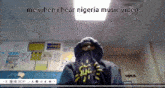 a person wearing a hoodie with the words " me when i hear nigeria music video " above them