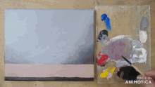 a painting is being painted next to a palette with the words made in animatica on it