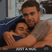 two shirtless men hugging each other with the words just a hug in the corner