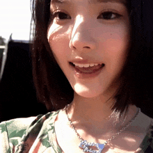 a close up of a woman wearing a necklace that says " i love you "