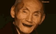 a close up of an elderly man 's face with a smile on it .