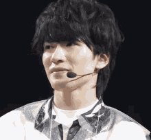 a man wearing a microphone on his ear looks at the camera