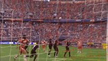 a soccer game is being played in a stadium with advertisements for walgreens