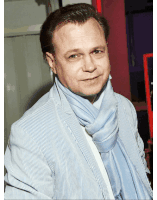 a man wearing a striped jacket and a blue scarf