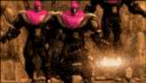three robots with pink heads are standing next to each other in a cave