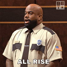 a man in a uniform says " all rise "
