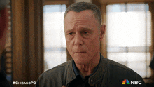 a close up of a man 's face with the chicagopd written on the bottom