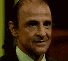 a close up of a man making a funny face with his mouth open