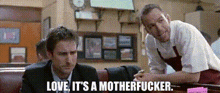 two men are sitting at a table with the words love it 's a motherfucker on the screen