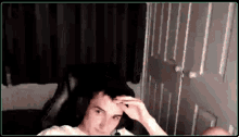 a man wearing headphones is sitting in a chair in a room .