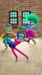 a group of colorful dolls are dancing in front of a brick wall