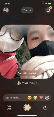 a man and a woman wearing face masks are taking a selfie on a phone .