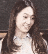 a close up of a woman 's face with long hair .