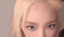a close up of a woman 's face with blue eyes .