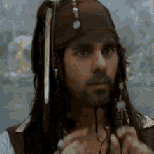 a man with dreadlocks and a beard is dressed as a pirate