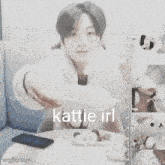 a girl is sitting at a table with a plate of food in front of her and the name kattle irl is visible
