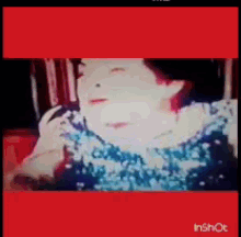 a woman is talking on a phone with a red border