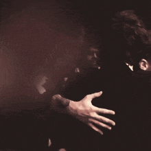 a man is hugging a woman in a dark room .