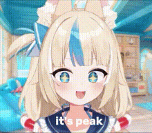a girl with blonde hair and blue eyes is standing in a room .