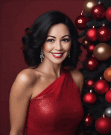 a woman in a white dress is in front of a christmas tree