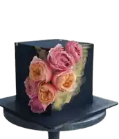 a black cake with pink and orange roses and the word abc