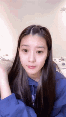 a girl with long hair wearing a blue sweatshirt that says ' abercrombie & fitch ' on it
